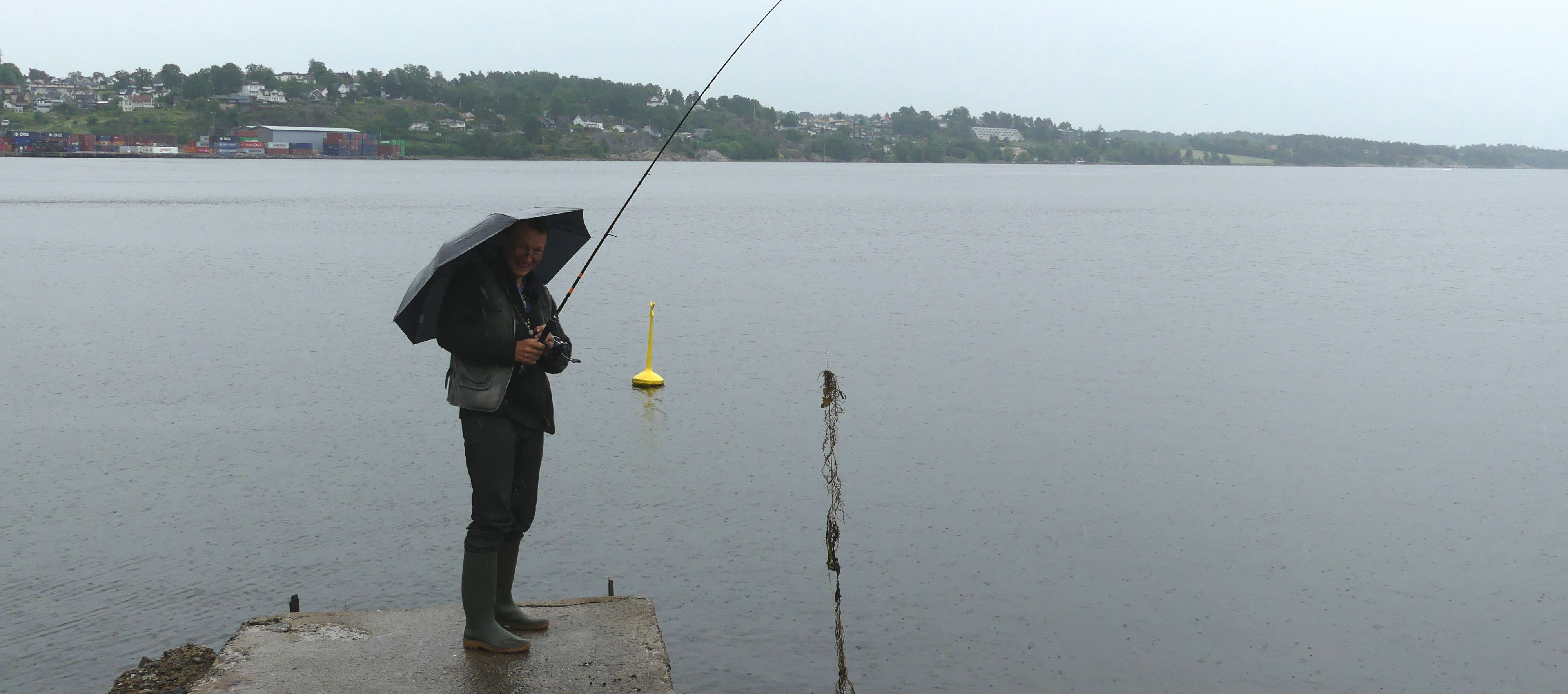 Jean-Paul à la pêche brave la pluie | Cliquer pour agrandir Photo qui montre Jean-Paul à la pêche brave la pluie | Cliquer pour agrandir